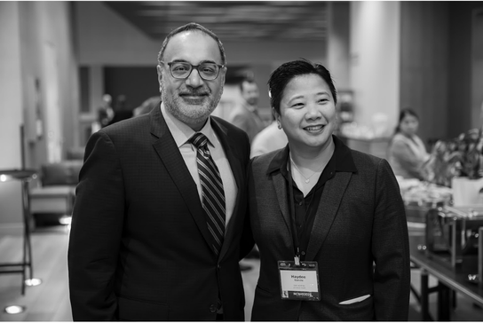 Two program directors pose together at the Structural Heart Summit, smiling toward the camera.